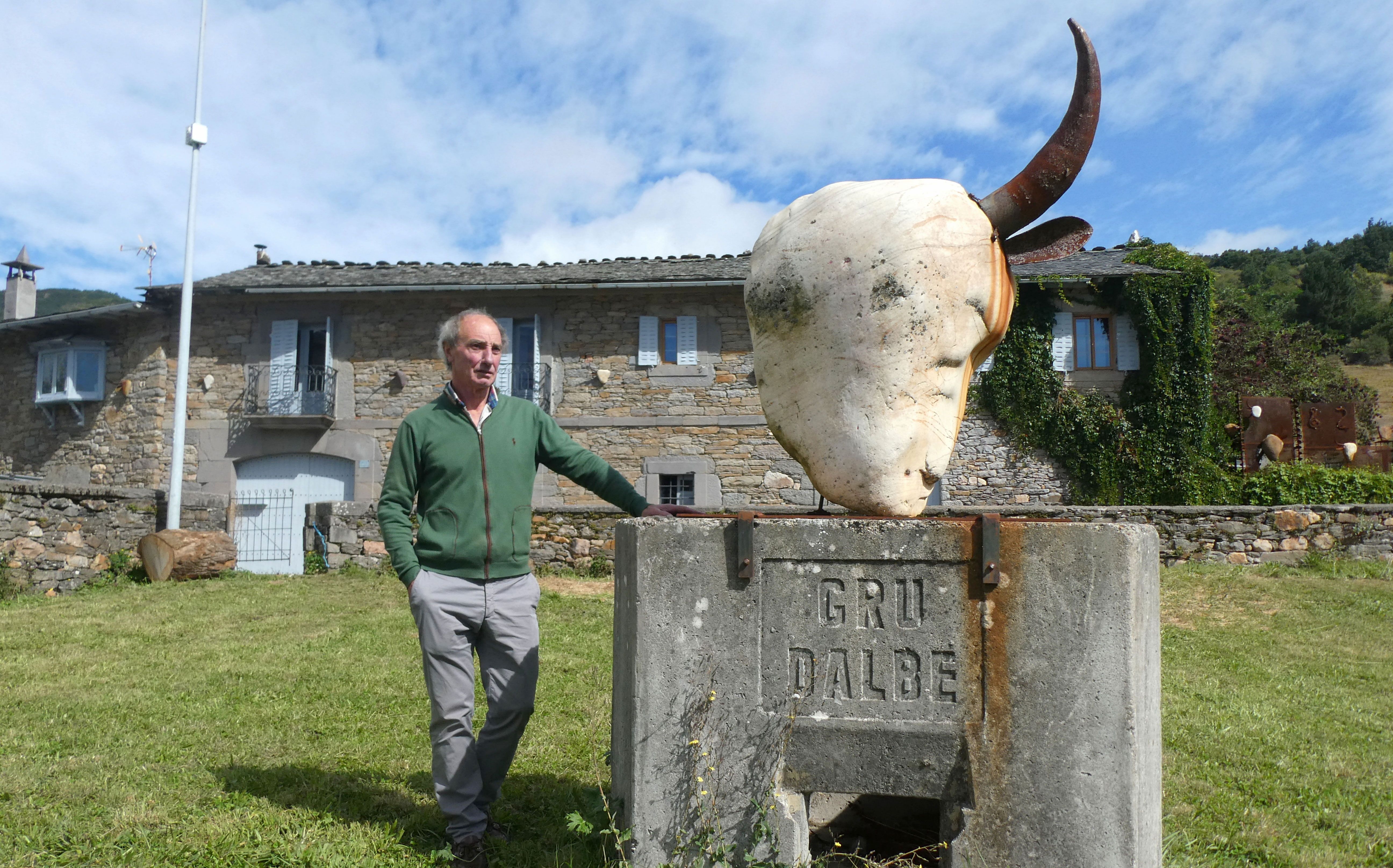 Lolo Zapico en su prado y con su vaca. | GREGORIO FERNÁNDEZ CASTAÑÓN